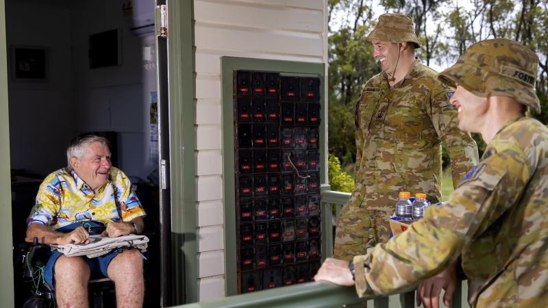 Warrant Officer Class Two Robert Elian and Warrant Officer Class Two Michael Foster (right) with Mr Gary Carr, Empire Vale Post Office manager, after providing flood damage clean-up assistance. Photo: Corporal Dustin Anderson