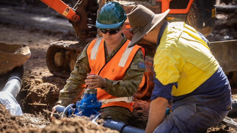 Sapper Brayden Taylor, from the 6th Engineer Support Regiment, works with Lismore Council workers repairing the Nimbin water pipeline. Photo: Corporal Jonathan Goedhart