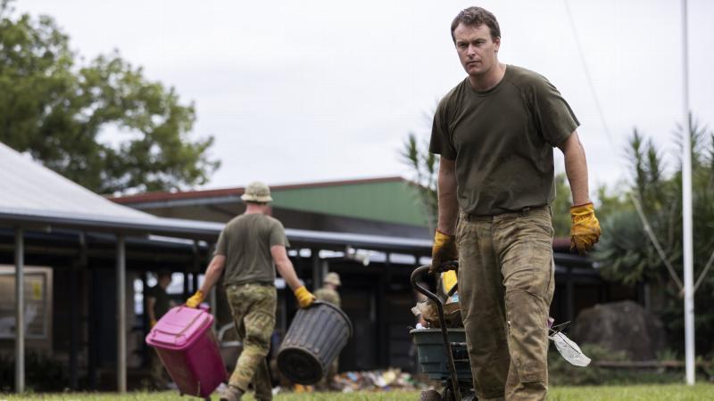 Gunner Jarrad Gardner clears debris at the flood-damaged Blakebrook Public School near Lismore, northern NSW, as part of Operation Flood Assist 2022. Photo: Corporal Sagi Biderman