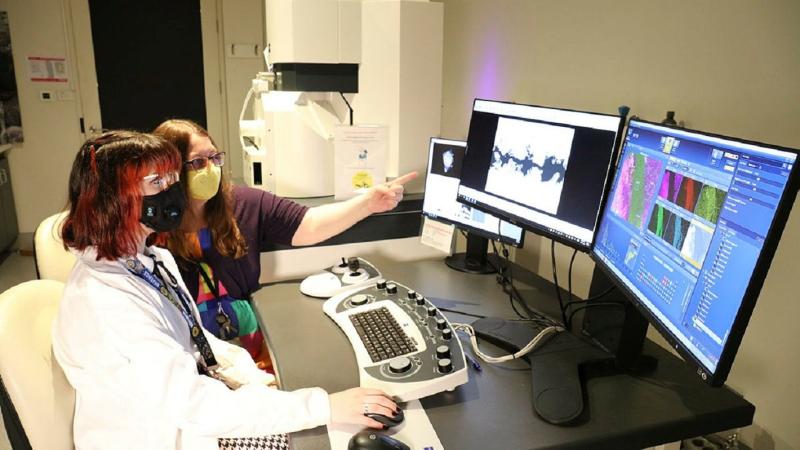 Defence Science and Technology Group scientist Sonya Slater, right, shows university student Charli Goodrich how to use equipment used in forensic analysis during Ms Goodrich's 12-month placement at Fishermans Bend, Victoria.