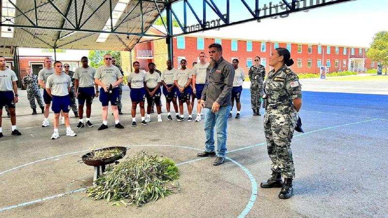Leading Seaman Breanna Jacobs-Rochford, right, and Uncle Shane Clarke from Bunurong Land Council Aboriginal Corporation speak to Navy Indigenous Development Program participants and recruit school staff at HMAS Cerberus, Victoria.