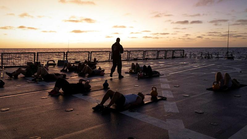 HMAS Hobart crew members attend a physical training session on board the ship. Photo: Leading Seaman Kylie Jagiello