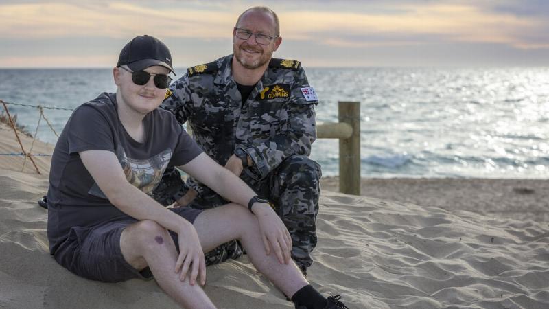 Warrant Officer Tim Cummins with his son, Jack, at Ship Wreck Bay in Golden Bay, Western Australia. Photo: Petty Officer Yuri Ramsey