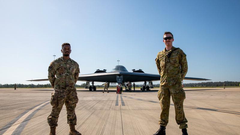 United States Air Force Senior Airman Reginald Dormeville and RAAF Aircraftman James Lunney in front of a United States Air Force B-2 Spirit from the 13th Bomb Squadron, at RAAF Base Amberley, Queensland. Photo: Leading Aircraftwoman Emma Schwenke