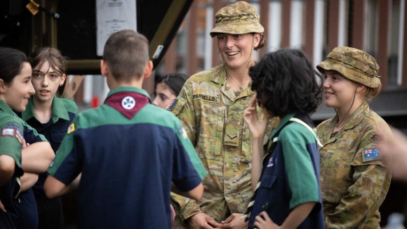 Army soldiers Lance Corporal Madison Parrello, centre, and Private Genna Price from 7th Battalion, Royal Australian Regiment, talk to 1st Lismore Scout Group scouts during Operation Flood Assist 2022. Photo: Corporal Jonathan Goedhart