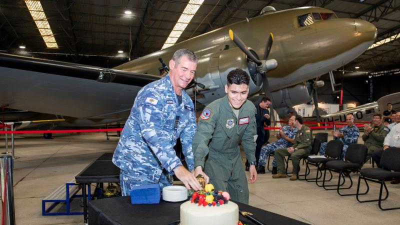 Senior ADF Officer Group Captain Iain Carty and United States Air Force's Airman First Class Alejandro Duarte cut the cake during 22nd Airlift Squadron anniversary celebrations at RAAF Base Amberley, Queensland. Photo: Leading Aircraftwoman Emma Schwenke