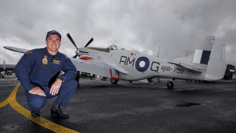 Air Force specialist capability officer Flight Lieutenant Ben Lappin, of No. 100 Squadron, with the Air Force Mustang aircraft at the Warbirds over Scone Air Show in the Hunter Valley, NSW. Photo: Corporal Craig Barrett