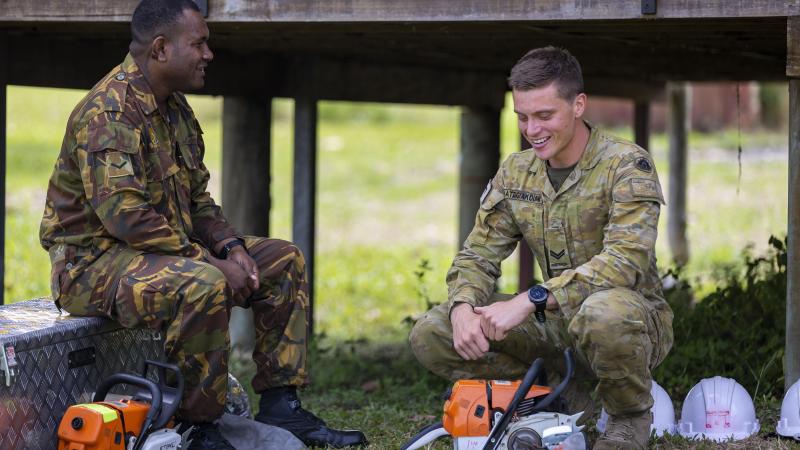 Australian Army soldier Corporal Miles Hatzigiakoumi (right) from 3rd Combat Engineer Regiment talks with Papua New Guinea Defence Force soldier Lance Corporal Christopher Jack at Igam Barracks in Lae, Papua New Guinea. Photo: Corporal Dustin Anderson