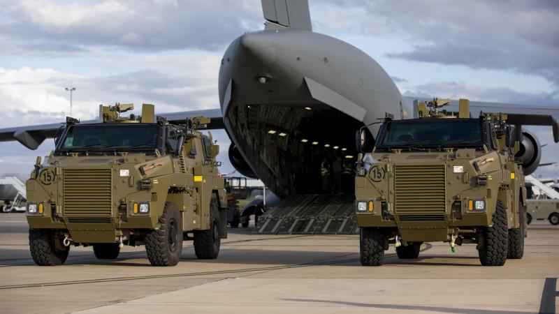Two Bushmaster protected mobility vehicles bound for Ukraine wait to be loaded onto a C-17A Globemaster III aircraft at RAAF Base Amberley. Photo: Leading Aircraftwoman Emma Schwenke 