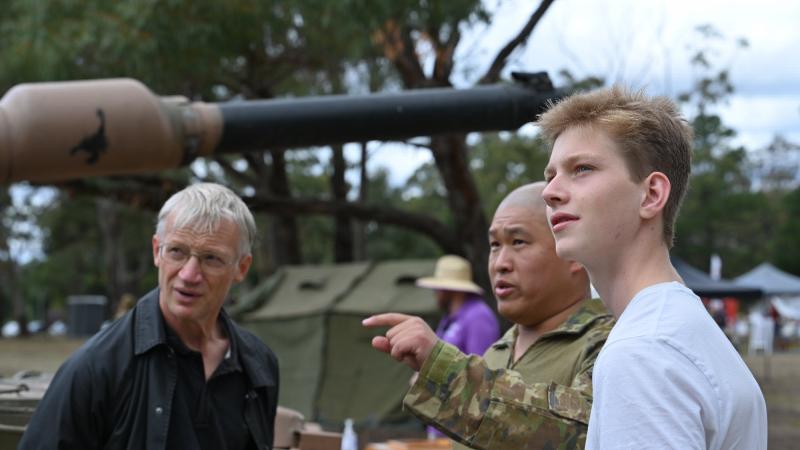 Sergeant Wei Huang, from the School of Armour, discusses the vehicles on display with Henry Rogers and his father, Tom, at the Puckapunyal Military Area community open day. Photo: Private Kelsey Innes