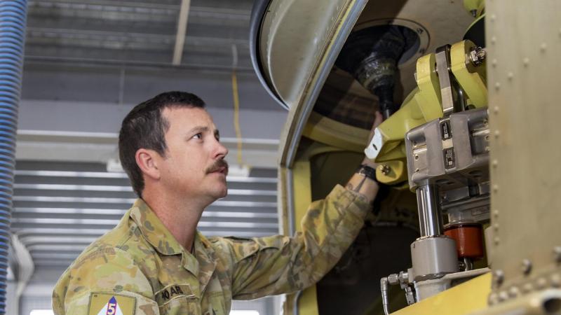 Sergeant Jason Hoare from 5th Aviation Regiment conducts maintenance on a CH-47F Chinook helicopter at RAAF Base Townsville. Photo: Corporal Lisa Sherman