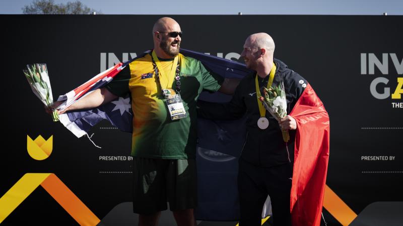 Invictus Games 2020 Team Australia competitor Steve James, left, celebrates receiving a gold medal in the mixed IF5678 discus event at the athletics meet at Invictus Games Park in The Hague, Netherlands.