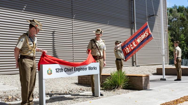 Commander of Forces Command, Major General Matthew Pearse, AM, and Commanding Officer, 12th Chief Engineer Works, Lieutenant Colonel Jon Pollard, unveil the new sign denoting the unit's Headquarters during the re-raising ceremony at Gallipoli Barracks, Br