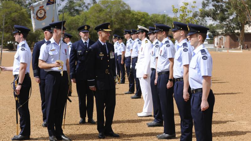 Commander of Air Combat Group, Air Commodore Tim Aslop, centre, talks with a Air Force officer from No. 265 PC-21 Australian Defence Force pilots course during the graduation ceremony at RAAF Base Pearce, Western Australia. Photo: Chris Kershaw
