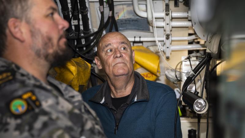 Nephew of Ordinary Seaman the late Edward "Teddy" Sheean VC, Garry Ivory, watches Chief Petty Officer Kerrin Lyon steer the submarine HMAS Sheean during a sea ride. Photo: Leading Seaman Daniel Goodman
