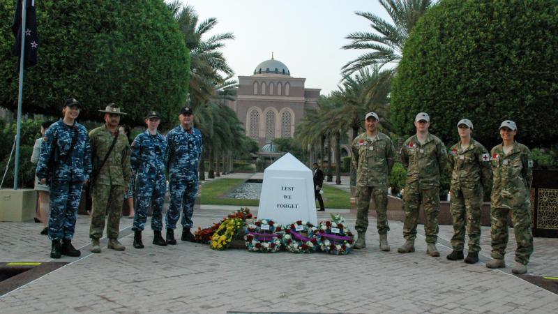 Australian Defence Force and New Zealand Defence Force personnel stand by the cenotaph after the Anzac Day commemorations in Abu Dhabi, United Arab Emirates. Photo: Captain Edward Pym