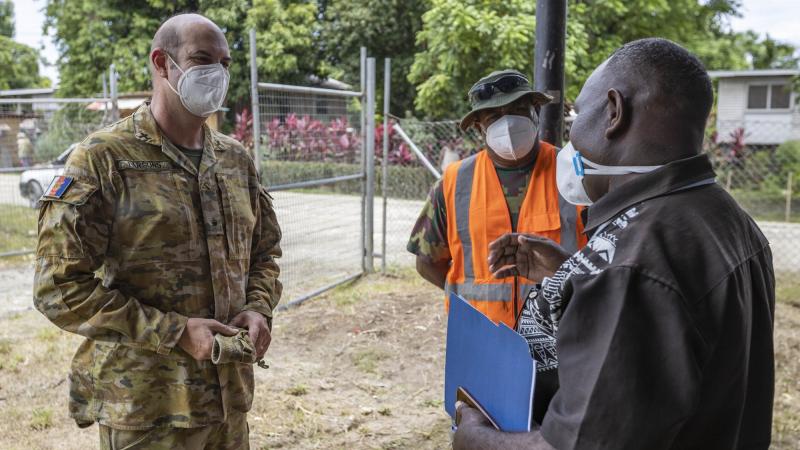 Chaplain Haydn Parsons talks with Republic of Fijian Military Forces soldier Staff Sergeant Eliki Seasea, centre, and Pastor Martin Nehemiah at Burns Creek Clinic in Solomon Islands. Photo: Cpl Jarrod McAneney