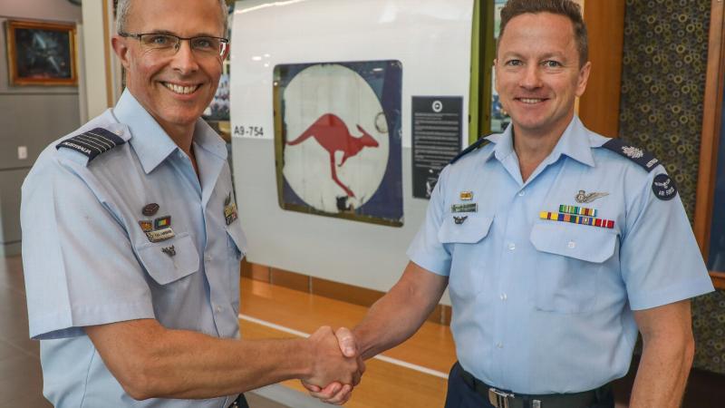 Officer Commanding of No. 92 Wing, Group Captain Paul Carpenter (left), officially hands over the P-3 Orion A9-754 memorial display to sergeants' mess committee chairman Warrant Officer Peter Christensen at RAAF Base Edinburgh in Adelaide.  