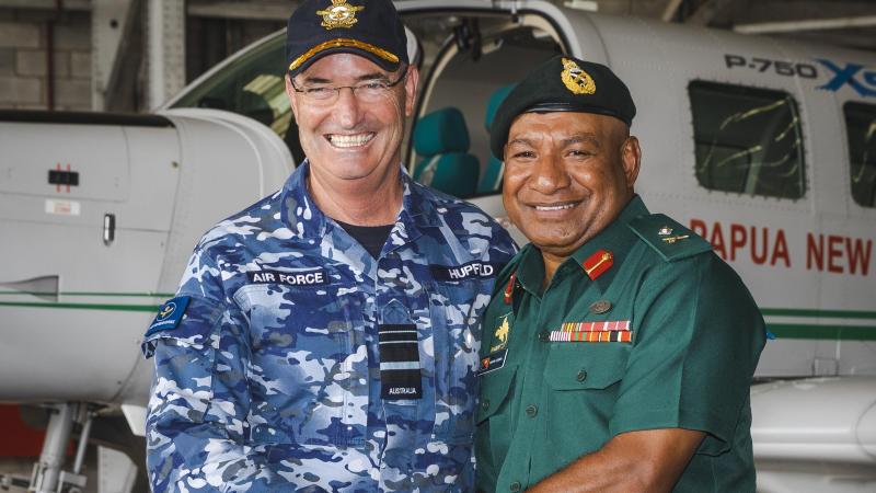Chief of Royal Australian Air Force, Air Marshal Mel Hupfeld and Major General Mark Goina (right), Chief of Papua New Guinea Defence Force, shake hands after signing an aviation safety memorandum of understanding at Air Transport Wing in Port Moresby