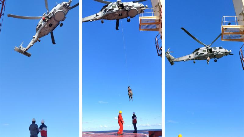 HMAS Parramatta’s MH-60R Seahawk helicopter winches the patient from the deck of Sea Angel bulk carrier. Photo courtesy of AMSA