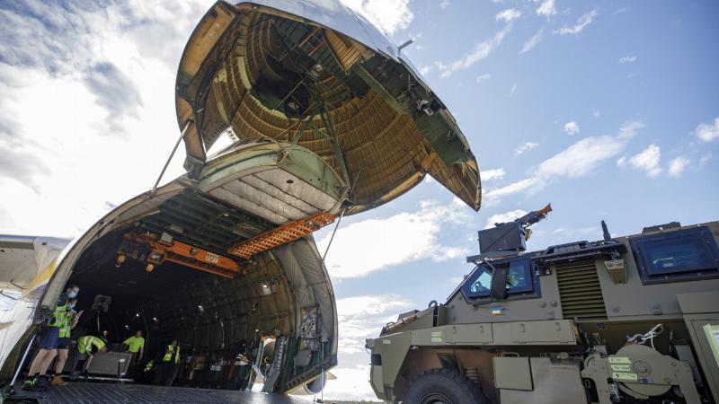 An Australian Government-donated Bushmaster protected mobility vehicle bound for Ukraine is loaded onto an Antonov AN-124 cargo aircraft at RAAF Base Amberley in Queensland.
