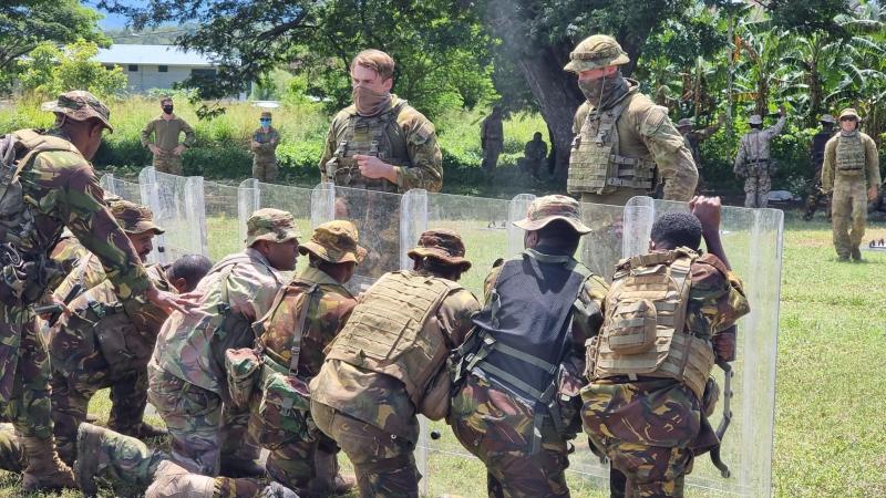 Australian Army soldiers provide guidance to PNGDF soldiers about creating a shield wall during population protection and control training as part of Exercise Olgeta Warrior.
