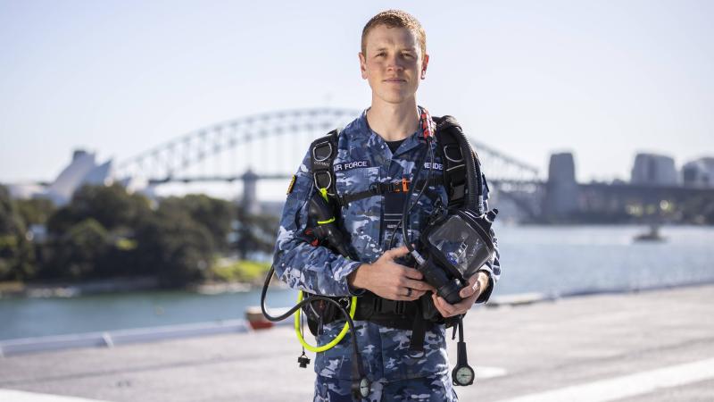 Flight Lieutenant Kristian Henderson with his dive gear on board HMAS Adelaide's alongside Garden Island. Photo: Leading Seaman Matthew Lyall