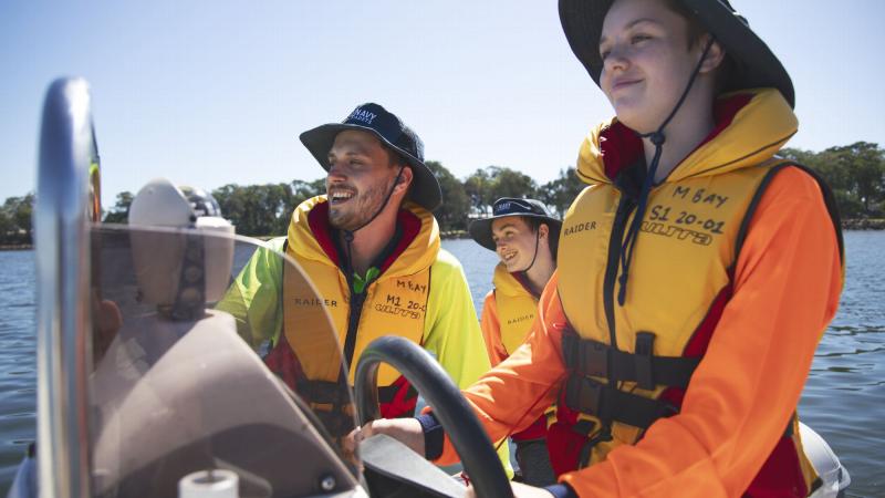 Australian Navy Cadet instructor Lieutenant AJ Hughes instructs Cadet Seaman Charlee Bell how to drive a rigid-hulled inflatable boat. Photo: Sam Thies