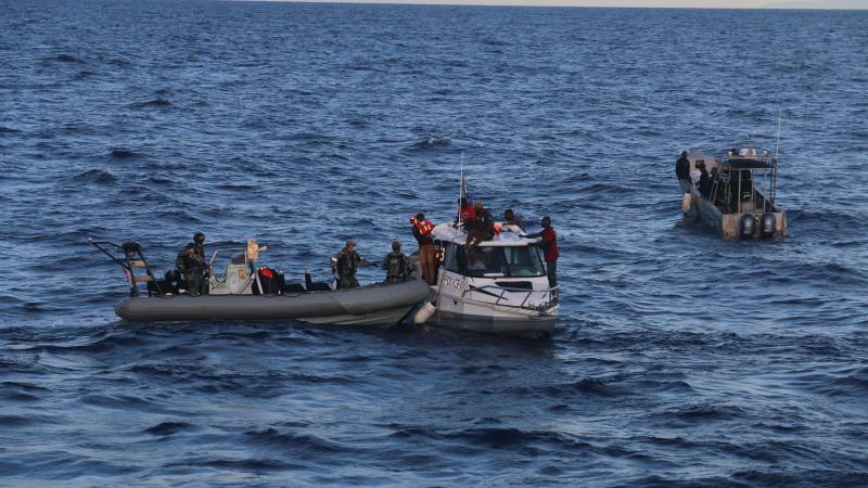 Royal Australian Navy personnel transfer passengers from a stricken Royal Solomon Islands Police Force vessel to HMAS Ararat on May 21