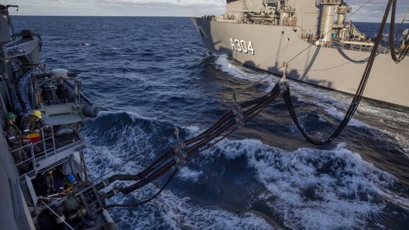 A fuel line is padded from HMAS Stalwart, right, to HMAS Parramatta during Stalwart's first replenishment at sea. Photo: Leading Seaman Leo Baumgartner