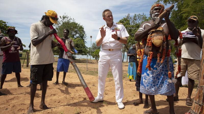 Mr Djambawa Marawili conducts a welcome ceremony for Chief of Navy Vice Admiral Michael Noonan, accompanied by Mudiny Mudiny Dhamarrandji playing the didgeridoo. Photo: Petty Officer Bradley Darvill