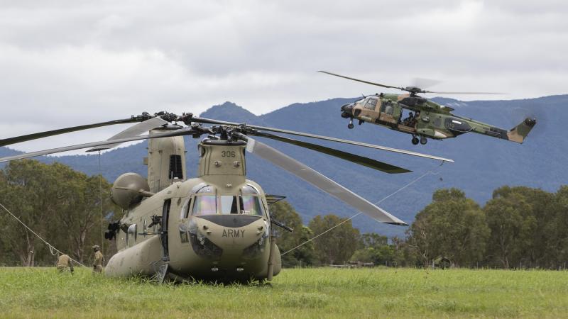 Australian Army MRH90 Taipan from the 5th Aviation Regiment prepares to land behind the CH-47F Chinook during Exercise Vigilant Scimitar at Ingham Airport, Queensland. Photo: Corporal Jarrod McAneney