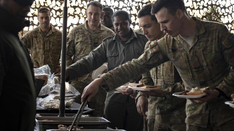 Soldiers from the Republic of Fiji Military Forces share a traditional Fijian Lovo with Australian Army soldiers from 8/9 RAR during the closing ceremony of Exercise Coral Soldier at Gallipoli Barracks, Brisbane. Photo: Corporal Nicole Dorrett