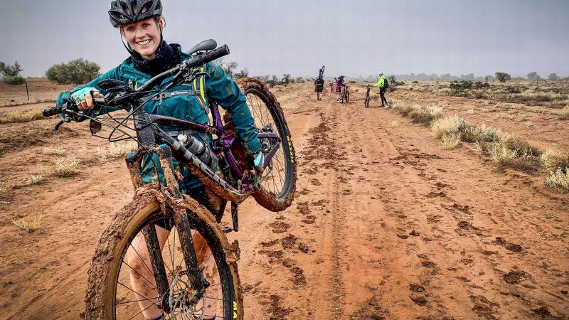 Flying Officer Kaylee Verrier carries her bike through some muddy terrain during the adventure-networking expedition. Photo: Corporal Melina Young