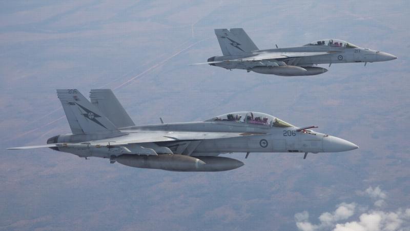 Two Royal Australian Air Force F/A-18F Super Hornets prepare to refuel from a KC-30A Multi-Role Tanker Transport aircraft over the Northern Territory during Exercise Diamond Storm 2022