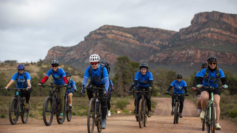 The Women's Integrated Networking Group 'WINGs in the Eyre 22’ cyclists ride with the Flinders Rangers backdrop during the inaugural adventure-networking expedition