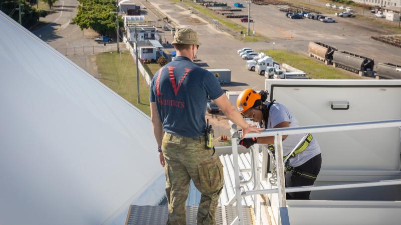A soldier from 4th Regiment, Royal Australian Artillery, supports an absiler taking part in the Brighter Lives fundraiser Abseil for Health at Queensland Country Bank Stadium in Townsville. Photo: Gunner Gregory Scott
