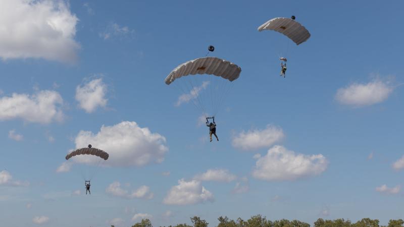 Combat controllers from No. 4 Squadron parachute into Mount Bundey training area in the Northern Territory during Exercise Diamond Storm. Photo: Leading Aircraftman Sam Price