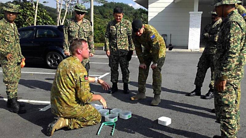 WO2 Cameron Elliott provides training to a Malaysian explosives detection dog section during Exercise Anjing Perang in 2017.