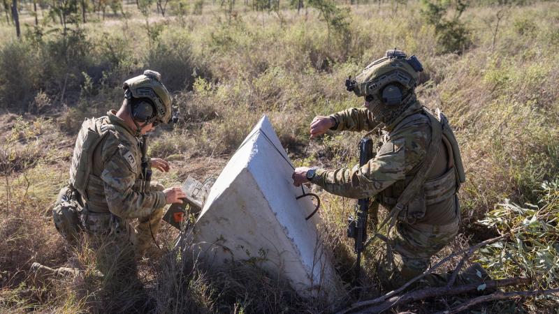 Australian Army soldiers from the 3rd Combat Engineer Regiment prepare to detonate a satchel charge during a breaching activity on Exercise Thunder Rage at Townsville Field Training Area on June 13, 2022. Photo: Gunner Gregory Scott