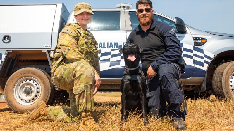 Royal Australian Air Force military working dog handler Leading Aircraftwoman Taylah Cole greets an Australian Federal Police working dog and her handler at RAAF Base Darwin. Photo: Leading Aircraftman Sam Price