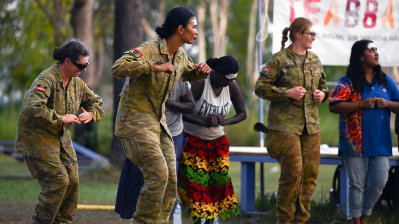 Australian Army soldiers join members of the Gapuwiyak community in performing traditional dances during the Army Aboriginal Community Assistance Program 2022 opening ceremony in Gapuwiyak, Northern Territory. Photo: Corporal Lucas Petersen