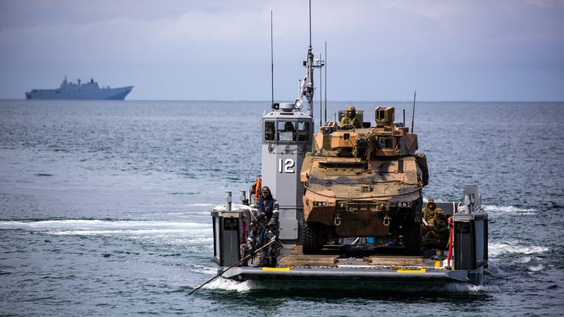 An Australian Army Boxer combat reconnaissance vehicle from 2nd/14th Light Horse Regiment is transported on one of HMAS Adelaide's landing craft during Exercise Sea Explorer 2022. Photo: Corporal Cameron Pegg
