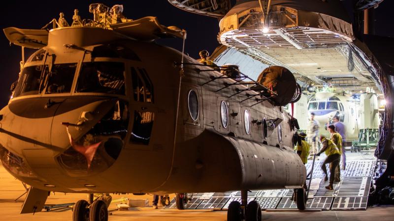 One of two new Australian Army CH-47F Chinooks is unloaded from a United States Air Force C-5M Super Galaxy aircraft at RAAF Base Townsville. Photo: Corporal Lisa Sherman