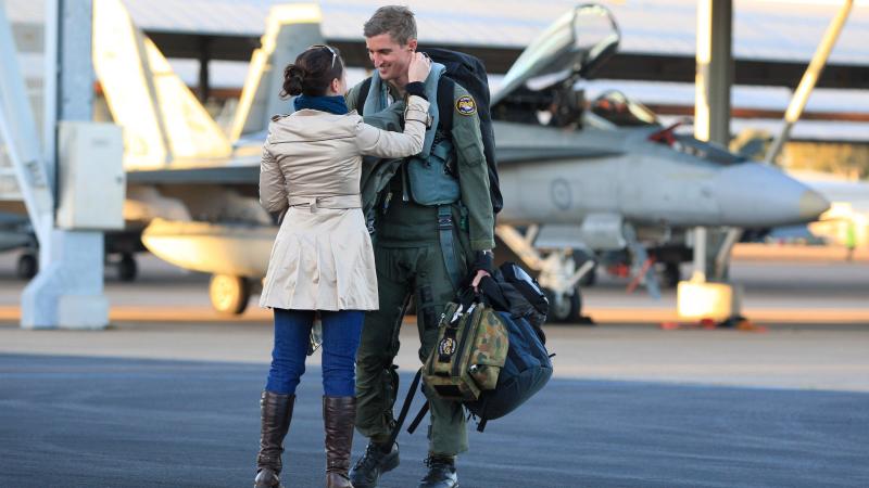 Wing Commander Martin Parker is greeted by his wife Chantelle on returning  from the final mission of his fighter combat instructor course in 2011. Leading Aircraftman Mark Friend