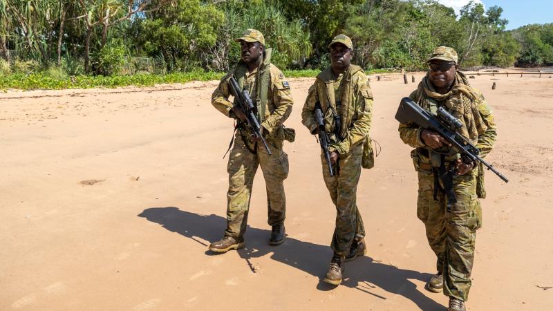 Norforce Darwin Squadron soldiers, Private Peter Puruntatameri, left, Private Blake Carter and Private Misman Kris on a beach in Melville Island during a community engagement visit to the Tiwi Islands. Photo: Leading Seaman Nadav Harel