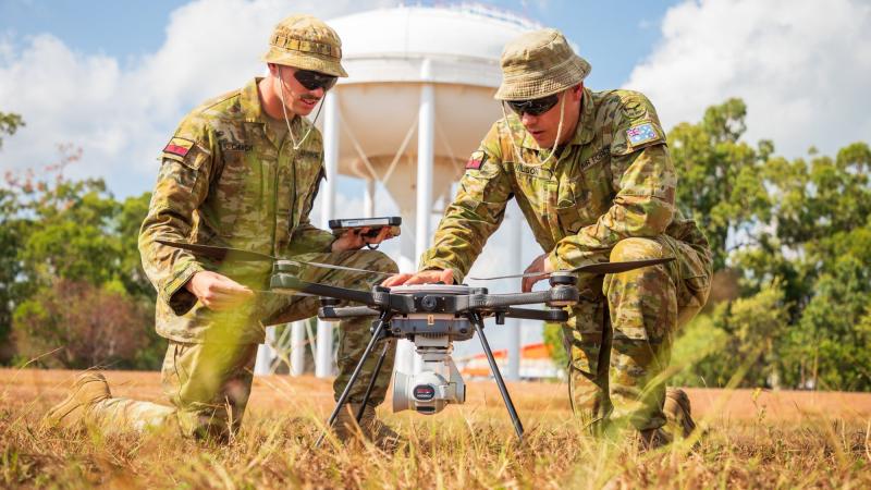 Air Force Security Aircraftman Joshua Church, left, and Airfield Defence Guard Leading Aircraftman David Wilson conduct a post-flight inspection of the R70 Sky Ranger unmanned aerial system. Photo Leading Aircraftman Sam Price