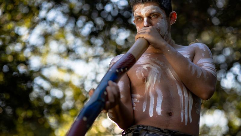 Royal Australian Navy's inaugural Indigenous cultural performer, Able Seaman Aviation Support Lynton Robbins plays the yidaki/didgeridoo at Garden Island Defence Precinct, Sydney. Photo: Able Seaman Susan Mossop