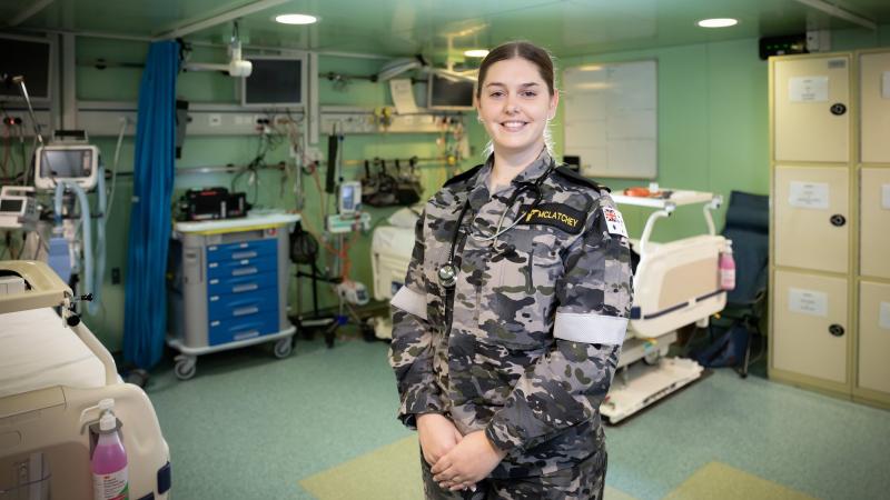 Seaman Medic Laine McLatchey stands in the sick bay onboard HMAS Canberra while at sea during Exercise Rim of the Pacific 2022. Photo: Leading Seaman Matthew Lyall