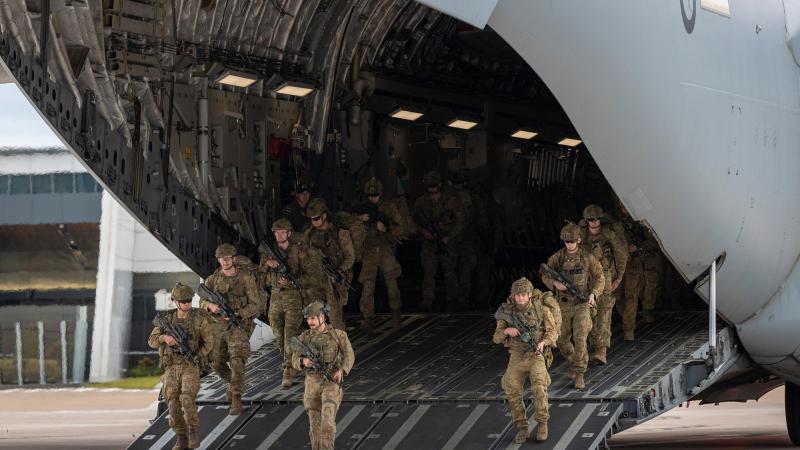 Army riflemen from Bravo Company of the 8th/9th Battalion, The Royal Australian Regiment, dismount a Royal Australian Air Force C-17A Globemaster after arriving at Toowoomba Airport. Photo: Corporal Nicole Dorrett